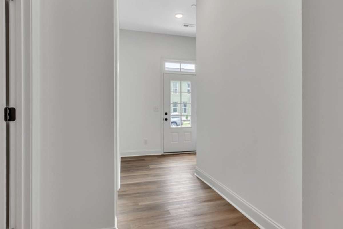 Notice the modern glass front door with the transom window above for maximum natural light.