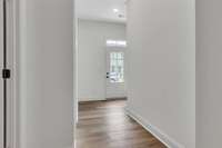 Notice the modern glass front door with the transom window above for maximum natural light.