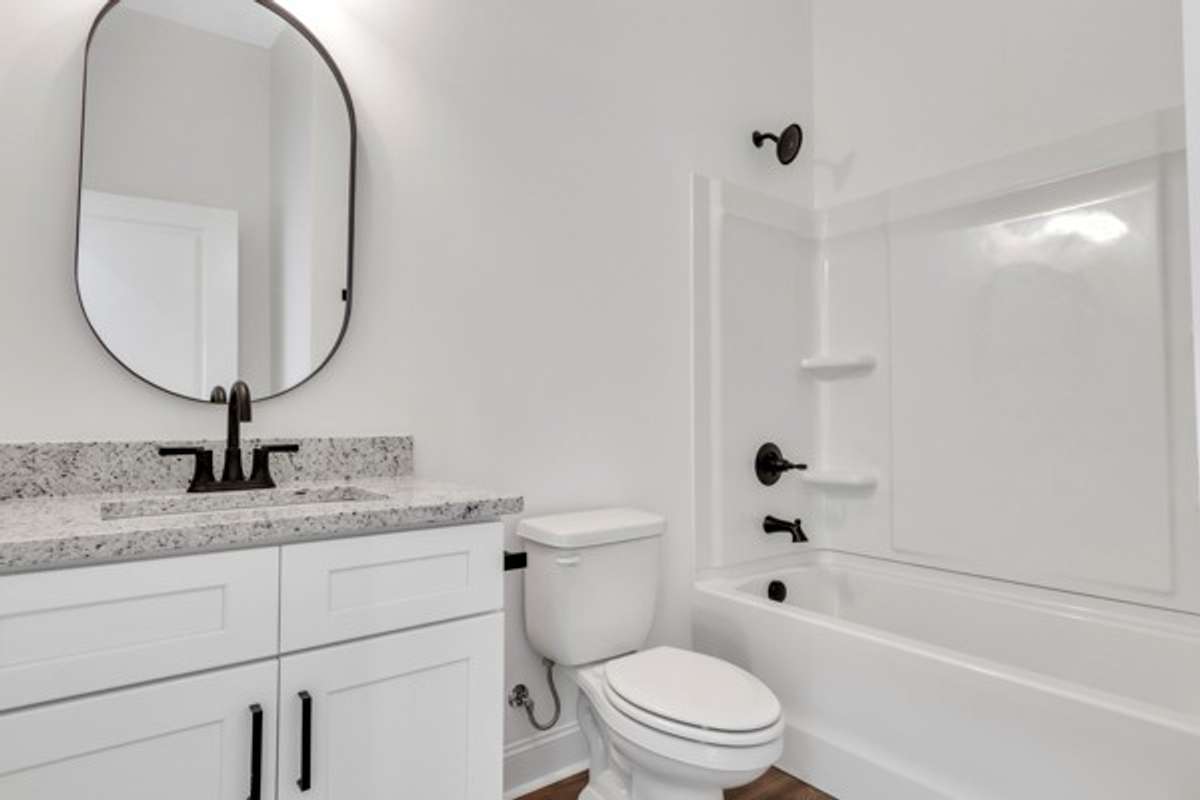 1st floor full bath with quick access to entry foyer, guest bedroom and garage.