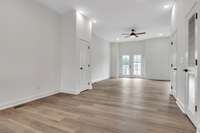 The dining area is conveniently located at the top of the stairs between the open floor plan kitchen and spacious living space. There is an additional pantry closet on the left and a coat closet on the right in photo.