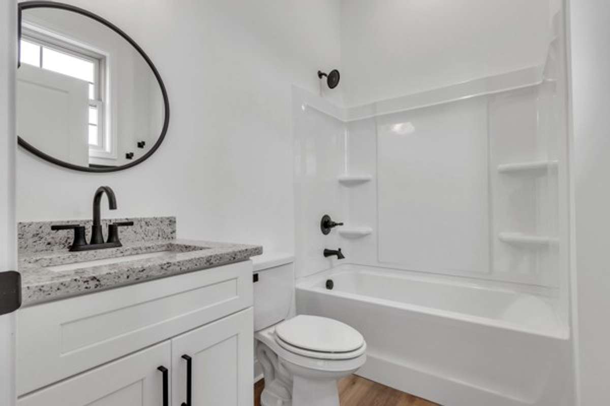 Private bath for guest room with window for added natural light.