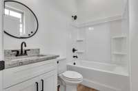 Private bath for guest room with window for added natural light.