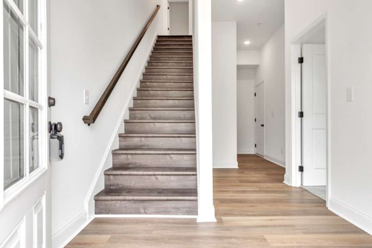 As you enter the 1st floor a private guest bedroom is on the right and then a full bath, coat closet and entrance to 2 car garage.