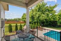 COVERED BACK PORCH LEADING TO THE POOL