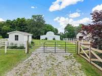 Garden shed (left) 4 stall barn with wash station, electric waterers, and haymow (middle) Indoor and outdoor arenas to the right