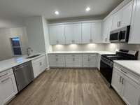 Oversized kitchen with quartz countertops.