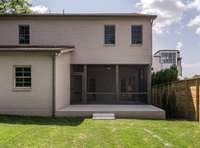 This expanded view showcases the generous uncovered patio perfect for grilling or enjoying a meal on a sunny day.