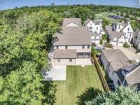 A stunning bird’s-eye view of this beautifully crafted home, showcasing its prime location. Don't be surprised to see runners, mom's with strollers, or couples walking their dogs down the tree lined neighborhood streets.