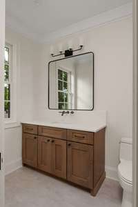 Modern and refined, this bathroom vanity showcases quartz countertops, custom cabinetry, and elegant fixtures.