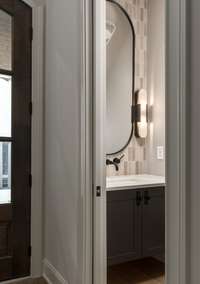 A glimpse of style—this snapshot captures the custom entrance and sleek powder room, showcasing elevated design.