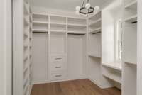 A dream-worthy walk-in closet featuring custom built-in systems, thoughtful organization, and ample space—designed to keep everything beautifully in place.