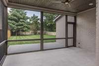 Just off the living room, enjoy year-round outdoor living on the covered, screened-in patio—perfect for relaxing or entertaining, with views of the professionally landscaped yard with full irrigation system.