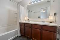 In the primary bathroom, the counter boasts double vanities for you and your partner to have your own space while getting ready for the day!