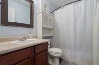 The second bathroom has a built-in shelf that is perfect for storing personal items and decor!