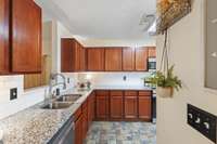 Granite countertops joined with oak cabinetry makes this kitchen a timeless masterpiece.