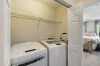 Hidden away, the laundry room offers overhead shelving, and space for quick storage.