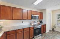 The kitchen boasts ceramic flooring and a nice pantry to keep the space tidy and neat.