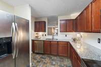 Boasting stainless steel appliances, the kitchen is complete with a side-by-side fridge and SS dishwasher to make preparing and cleaning seamless.