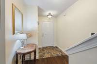 Steps away, the foyer offers a nice neutral area to welcome guests and store their belongings.