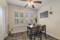 Plantation shutters adorn the home and give the space a warm and classic touch. Overhead, a ceiling fan adds comfort and style to the room.