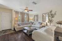 The updated living room is complete with a large open layout, hardwood flooring, and an electric fireplace to keep you cozy while relaxing with friends and family.