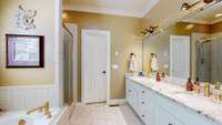 Master suite bathroom includes a step in shower, separate tub, double vanities, wet room and walk-in closet.