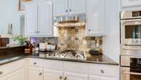 GE Cafe Monogram appliance package that includes a five burner gas cooktop, built in oven and Advantium Oven (microwave and oven combo).