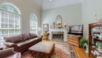 The great room/ living room boasts soaring 18-foot ceilings, more of the graceful arched windows and a cozy gas fireplace.
