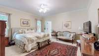 Primary bedroom en suite is extremely large.  Current owner is showcasing a king size bed, full bedroom suite and sitting area.