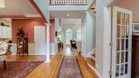 Front entryway.  Directly to the right is an office, currently being used as a sitting room.  Open Formal Dining Room on the left.