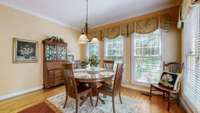 Floor to ceiling windows completely surround the breakfast nook which is open to the kitchen and with direct access to the back patio.