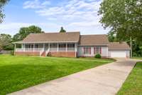 Concrete drive all the way up to both attached garage and detached garage.