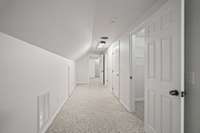 This is upstairs. There is a walk in closet, full bathroom, bonus/flex room, an extra room, and attic doors along the side of the rooms that will be great storage space.