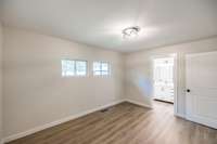 Primary Bedroom with built in wood shelves in closet