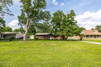 Large, level front yard with mature trees