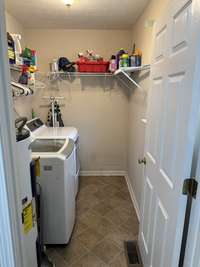 Separate utility room with wire shelving.