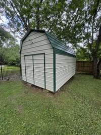 Well built storage building with low maintenance metal siding.