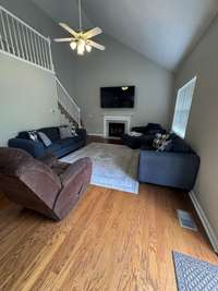 Living room with 16' ceilings height and fireplace insert.
