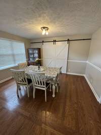Sliding barn doors in back leading to what could be used as an inlaw quarters.