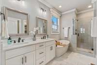 Luxurious and spa-like, this primary ensuite features dual vanities, a serene soaking tub, and a spacious shower with dual shower heads—designed for ultimate comfort and relaxation