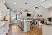 Open-concept living at its finest—this sleek white kitchen is the perfect gathering space.