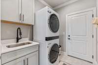 Located on the main level near the primary bedroom and off the living room is the laundry room. This space features a closet for extra storage or storm closet.