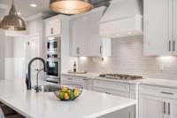 This kitchen features double ovens, a gas cooktop and whole home water filtration system