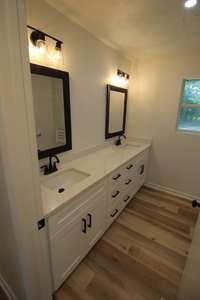 Double vanity with quartz counter top, new faucets, mirrors and lighting! New toilet and walk in shower.