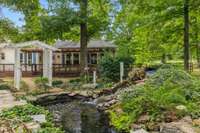Luscious Backyard with lots of greenery and a waterfall