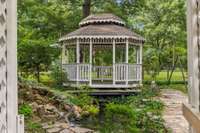 Gazebo located in the backyard featuring a tranquil koi pond