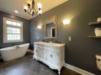 Primary Bath with a Brand New Flooring, Vanity &  Soaker Tub  located off the Primary Bedroom