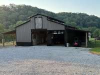 36x48 horse barn with 4 stalls, hay loft, electric and water.