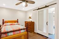 Primary bedroom has walk-in closet, full bath, hardwood floors, and recessed lighting.