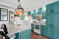 Kitchen features granite countertops, custom cabinets, pantry, and recessed lighting.